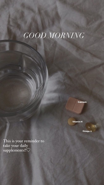 A soft-focus, overhead lifestyle shot showing a glass of water next to daily supplement pills with a simple morning reminder text overlay.